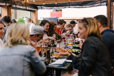 Group chatting outdoors at restaurant