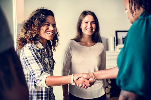 women shake hands upon meeting